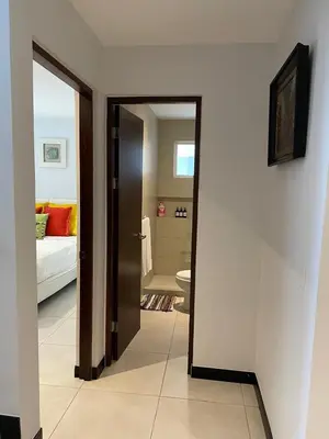a hallway with a door leading to a bedroom at Ciudad del Mar 31 in Jacó