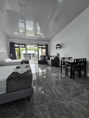 a large living room with a bed and a table at Cattleya Living Studio in Monteverde Costa Rica