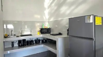 a small kitchen with a sink and a refrigerator at Cattleya Living Studio in Monteverde Costa Rica