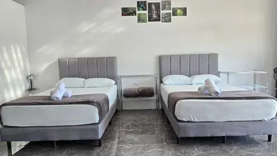 two beds with stuffed animals on them in a bedroom at Cattleya Living Studio in Monteverde Costa Rica