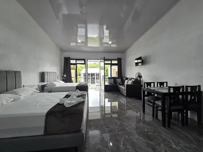 a bedroom with a bed and a table and a couch at Cattleya Living Studio in Monteverde Costa Rica