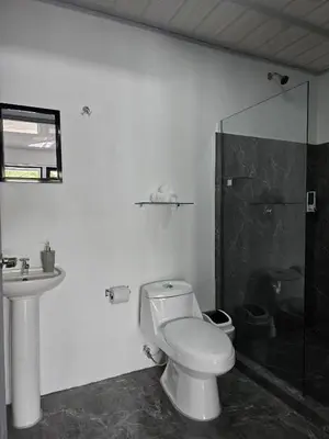 a bathroom with a toilet and a sink and a shower at Cattleya Living Studio in Monteverde Costa Rica