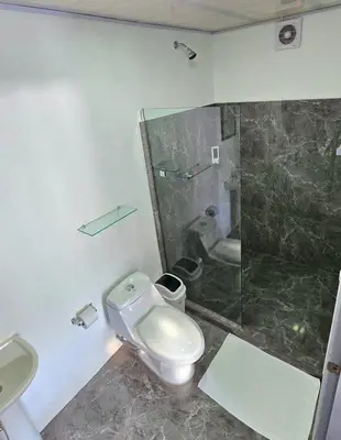 a bathroom with a toilet and a shower and a sink at Cattleya Living Studio in Monteverde Costa Rica