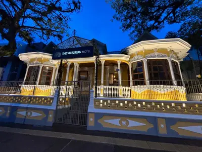 a yellow and white building on a street at The Victorian Hotel in San José