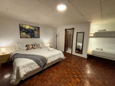 a bedroom with a large bed and a mirror at The Victorian Hotel in San José