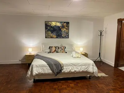 a bedroom with a bed with a painting on the wall at The Victorian Hotel in San José