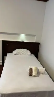 a bed with two towels on top of it at The Victorian Hotel in San José