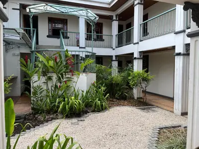 a courtyard of a building with plants at The Victorian Hotel in San José