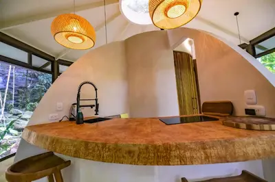 a kitchen with a large wooden counter in a room at The Nest Unique Jungle Retreat in Barú