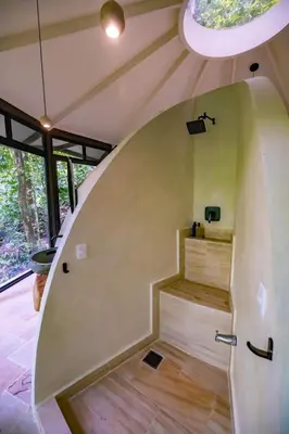 a spiral staircase in a house with a window at The Nest Unique Jungle Retreat in Barú
