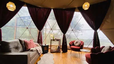 a living room with a large room with large windows at The SAFIRA Dome at FéLIZA Rainforest Domes in Monteverde Costa Rica