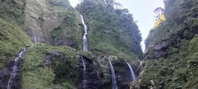 a waterfall in the middle of a canyon at Gringo Petes Too in Fortuna