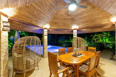 a dining room with a table and chairs and an aquarium at Green Villas Tamarindo in Tamarindo