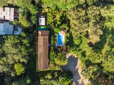 an overhead view of a yard with a pool and trees at Green Villas Tamarindo in Tamarindo