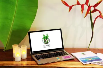 a laptop computer sitting on top of a wooden table at Oasis de las Palmas in Ojochal