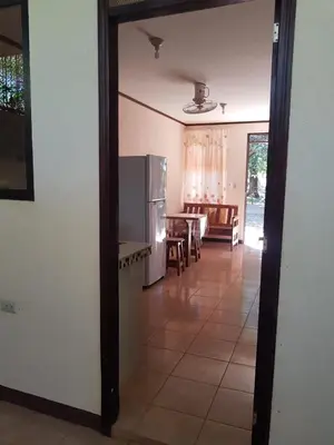 a kitchen with a refrigerator and a dining room at Cabinas en Playas del Coco in Sardinal