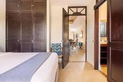 a bedroom with a bed and a desk and a table at Jaco Beachfront Oasis Newly renovated dream condo in Jacó