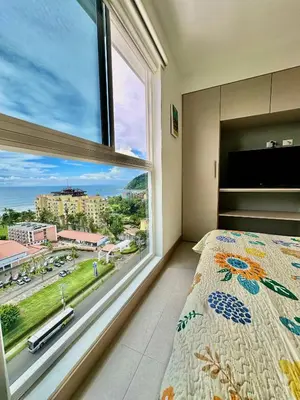 a bedroom with a large window and a bed at Grettabril JACO BEACH APARTMENT in Jacó