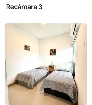 a bedroom with two beds and a window at Grettabril JACO BEACH APARTMENT in Jacó
