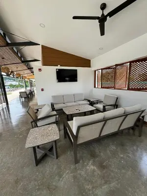 a living room with a couch and chairs and a tv at Grettabril JACO BEACH APARTMENT in Jacó