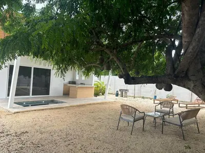 two chairs and a table under a tree at Antemar Guest, Beach bungalow near Conchal in Brasilito