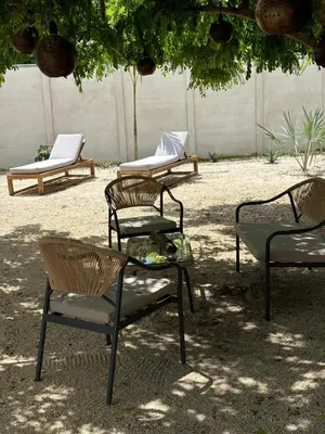 a group of chairs and tables in a yard at Antemar Guest, Beach bungalow near Conchal in Brasilito