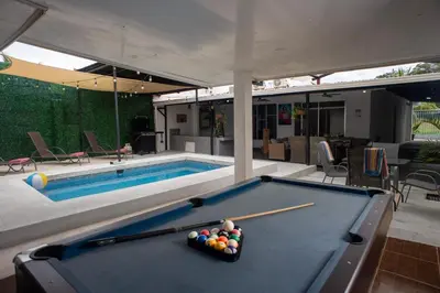 a pool table with balls on it next to a swimming pool at Casa Plata - 10 bed, 5 bdrm - One Block from Clubs in Jacó