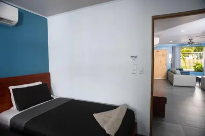 a bedroom with a bed and a living room at Casa Plata - 10 bed, 5 bdrm - One Block from Clubs in Jacó