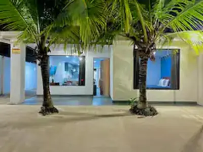 two palm trees in the middle of a building at Casa Plata - 10 bed, 5 bdrm - One Block from Clubs in Jacó