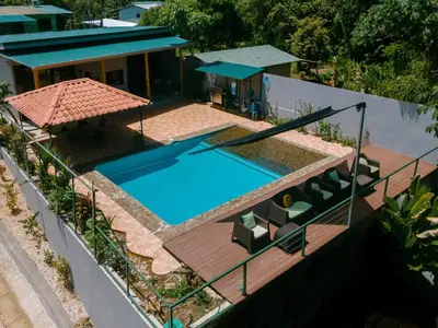 an aerial view of a house with a swimming pool at Jungle Glory Home Arriba in Manuel Antonio