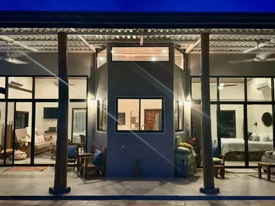 a room with a blue door and windows at Jungle Glory Home Arriba in Manuel Antonio