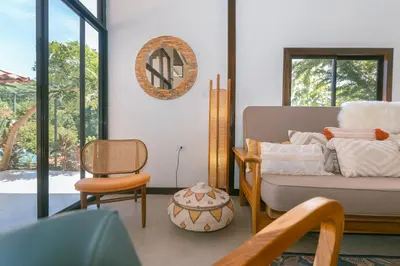 a living room with a couch and a chair at Jungle Glory Home Arriba in Manuel Antonio