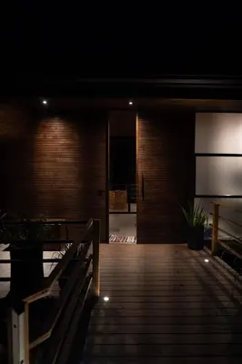 a dark room with a wooden deck with a bench at Casa VISTA PARAISO - Vista al mar - Selva - WIFI - Deck Yoga - Sunset in Santa Teresa Beach