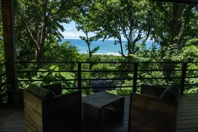 a view of the ocean from the deck of a house at Casa VISTA PARAISO - Vista al mar - Selva - WIFI - Deck Yoga - Sunset in Santa Teresa Beach