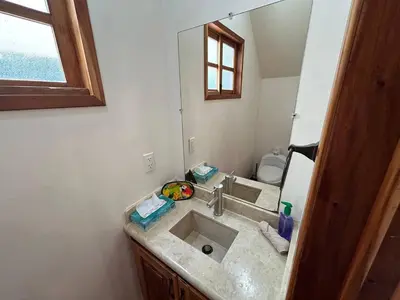 a bathroom with a sink and a mirror at 3 minutes walk from the best surf beach in area in Dominical