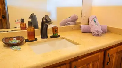a bathroom counter with a sink and a mirror at 3 minutes walk from the best surf beach in area in Dominical