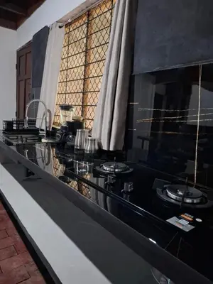 a black counter with two burners on it at Coco Beach House in Coco