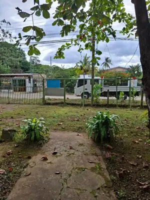 a park with a fence and two plants at Coco Beach House in Coco