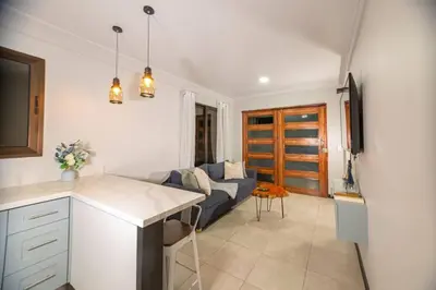 a kitchen and a living room with a couch at Casa Serenity Arenal,Fully Equip in Fortuna