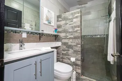 a bathroom with a toilet and a sink and a shower at Casa Serenity Arenal,Fully Equip in Fortuna