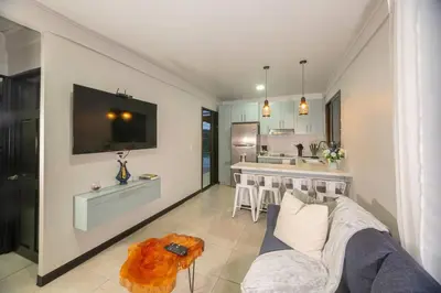 a living room with a couch and a kitchen at Casa Serenity Arenal,Fully Equip in Fortuna