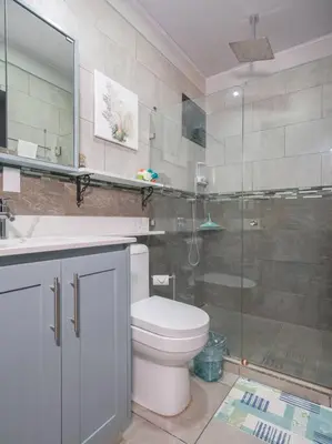 a bathroom with a toilet and a glass shower at Casa Serenity Arenal,Fully Equip in Fortuna