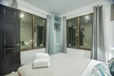 a bedroom with a bed with two towels on it at Casa Serenity Arenal,Fully Equip in Fortuna
