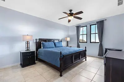 a bedroom with a bed and a ceiling fan at Coco Top-Floor 3-BD Ocean-View Unit at Pacifico By SPCR in Coco