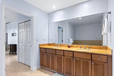 a bathroom with two sinks and a large mirror at Coco Top-Floor 3-BD Ocean-View Unit at Pacifico By SPCR in Coco
