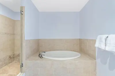 a bath tub in a bathroom with a shower at Coco Top-Floor 3-BD Ocean-View Unit at Pacifico By SPCR in Coco