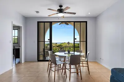 a dining room with a table and chairs and a ceiling fan at Coco Top-Floor 3-BD Ocean-View Unit at Pacifico By SPCR in Coco