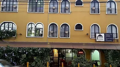 a yellow building with windows and a sign on it at Casa Echavarria in San José