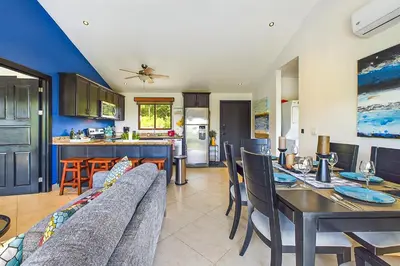 a kitchen and dining room with a couch and a table at Casa Tranquilo 26B - Beautiful Home With A Private Pool in Playa Flamingo