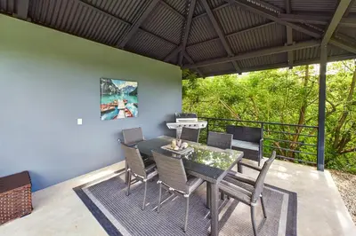 a dining room with a table and chairs on a patio at Casa Tranquilo 26B - Beautiful Home With A Private Pool in Playa Flamingo
